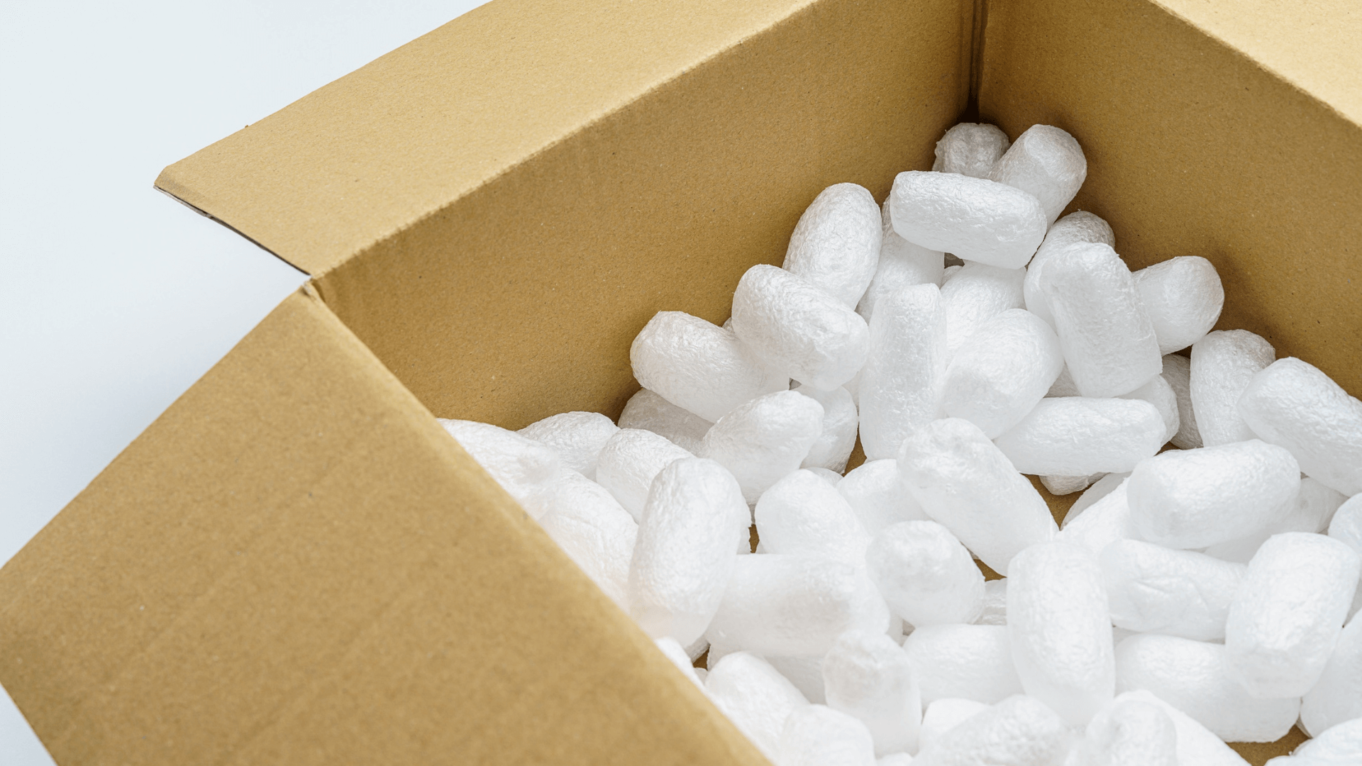 white packing peanuts in a cardboard box